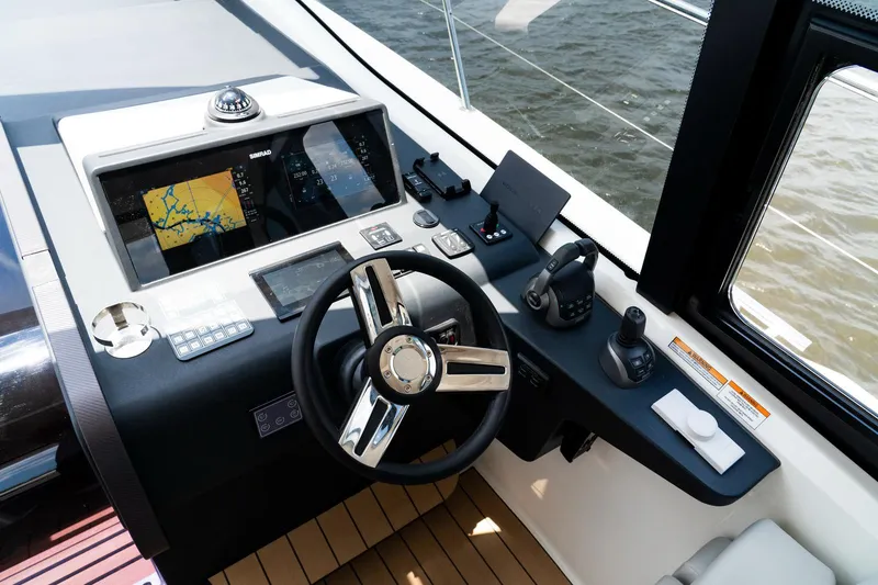 Slide: The Image of Helm of 2022 Bavaria SR41 yacht with navigation screens and controls. - 11