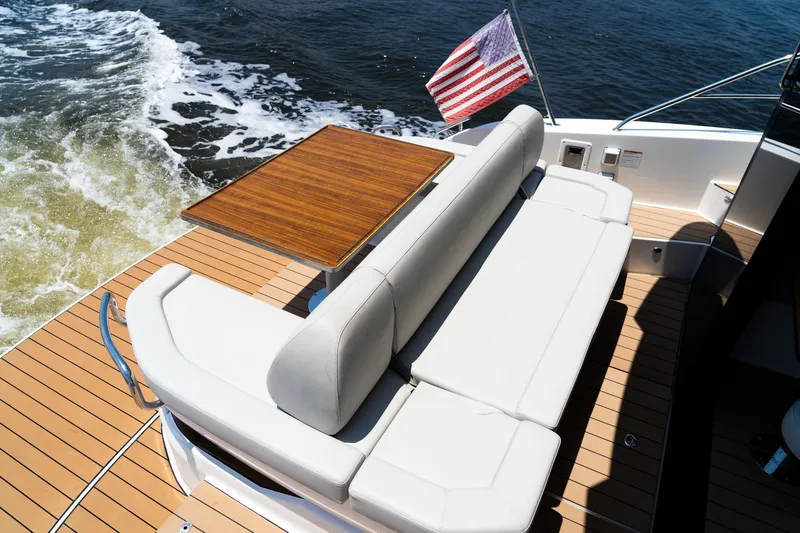 Slide: The Image of Luxury Bavaria SR41 yacht deck with seating, table, and American flag, 2022 model. - 14