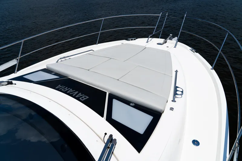 Slide: The Image of 2022 Bavaria SR41 yacht deck with sunbathing area, sleek design, and railing. - 7