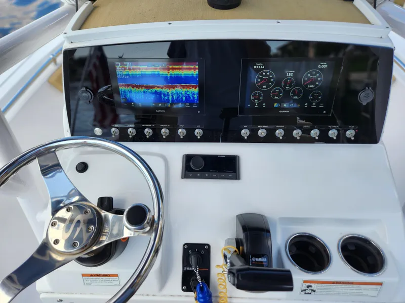 Slide: The Image of 2023 Sportsman Heritage 211 Center Console dashboard with navigation and control displays. - 15