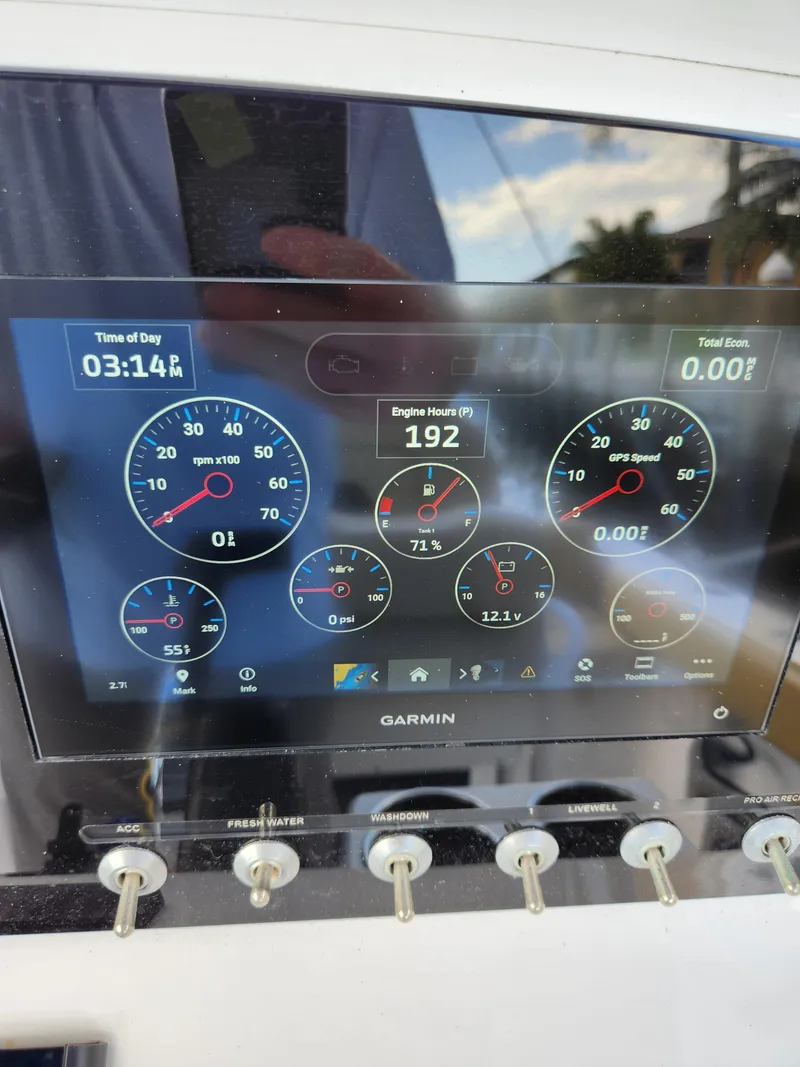 Slide: The Image of 2023 Sportsman Heritage 211 Center Console dashboard with Garmin display showing engine metrics. - 16