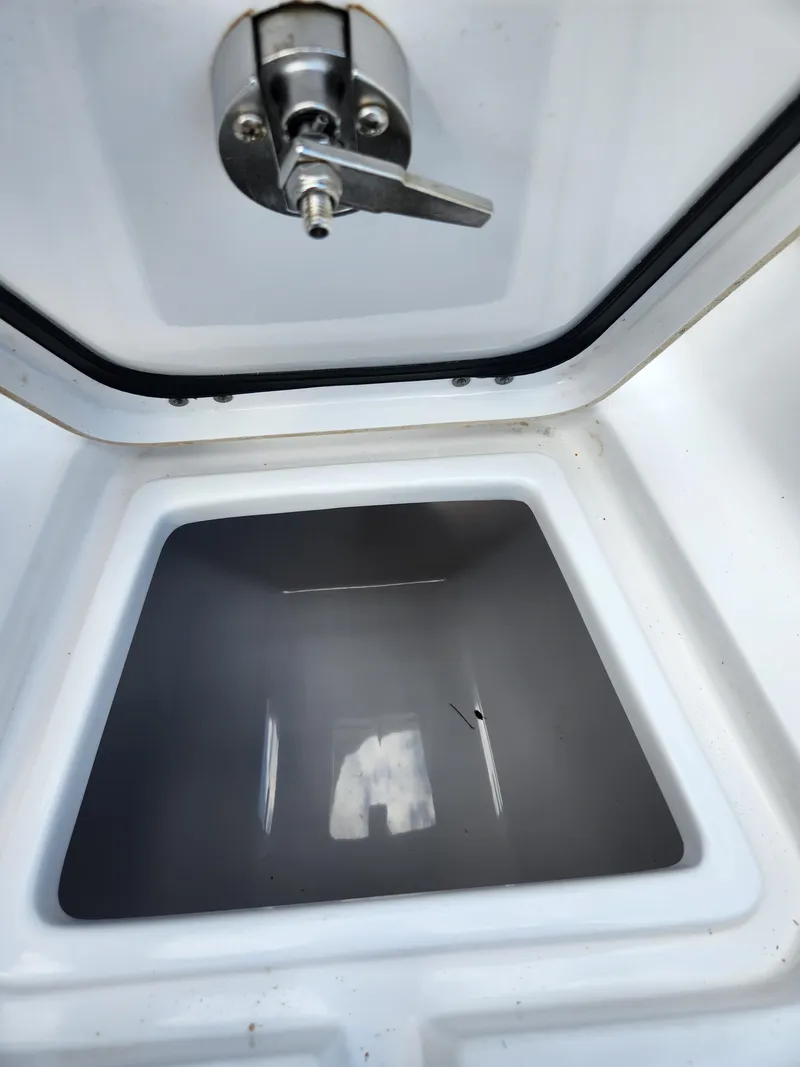 Slide: The Image of 2023 Sportsman Heritage 211 Center Console storage compartment with latch, open view. - 21