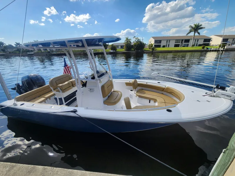 Slide: The Image of 2023 Sportsman Heritage 211 Center Console boat docked on a sunny day. - 24