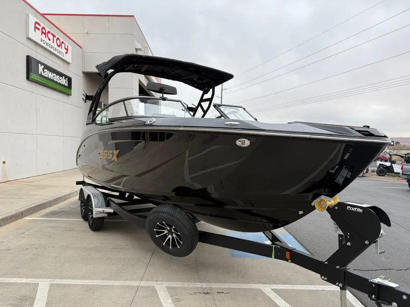 Slide: The Image of 2025 Yamaha Boats 255XD in black on trailer, parked outside dealership. - 10