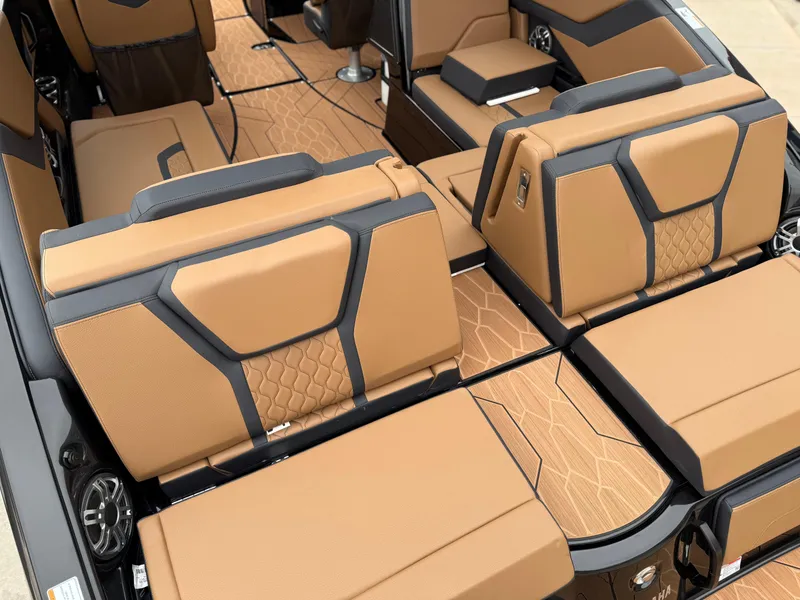 Slide: The Image of 2025 Yamaha Boats 255XD interior with tan and black seating, showcasing modern design and comfort. - 21