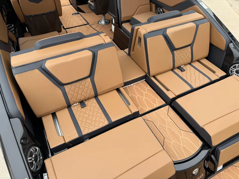 Slide: The Image of 2025 Yamaha Boats 255XD interior with luxurious tan and black seating. - 24