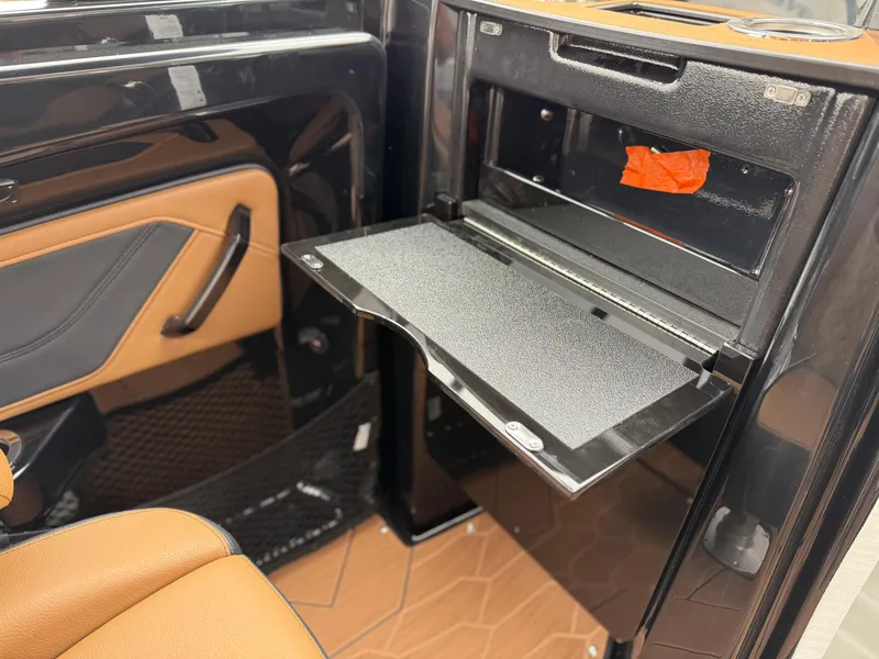 Slide: The Image of 2025 Yamaha Boats 255XD interior with storage compartment and sleek design. - 30