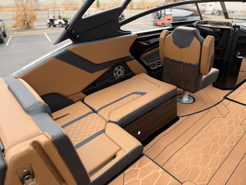 Slide: The Image of 2025 Yamaha Boats 255XD interior with luxurious tan and black seating, modern design. - 35