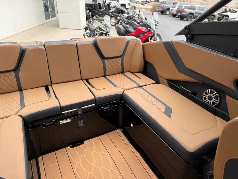 Slide: The Image of 2025 Yamaha Boats 255XD interior with tan and black seating, showcasing modern design and comfort. - 38