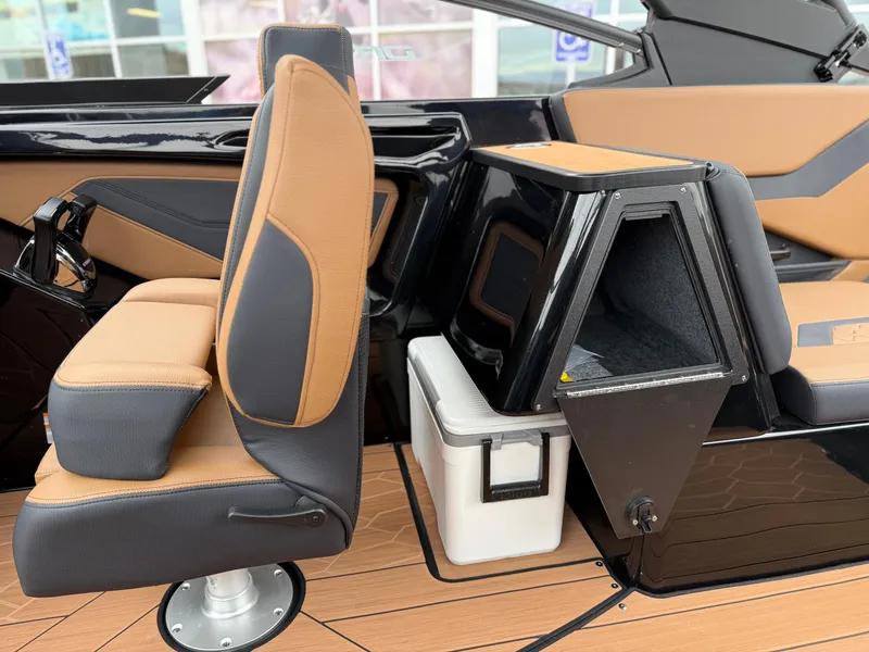 Slide: The Image of 2025 Yamaha Boats 255XD interior with tan and black seating, modern design, and storage compartment. - 44