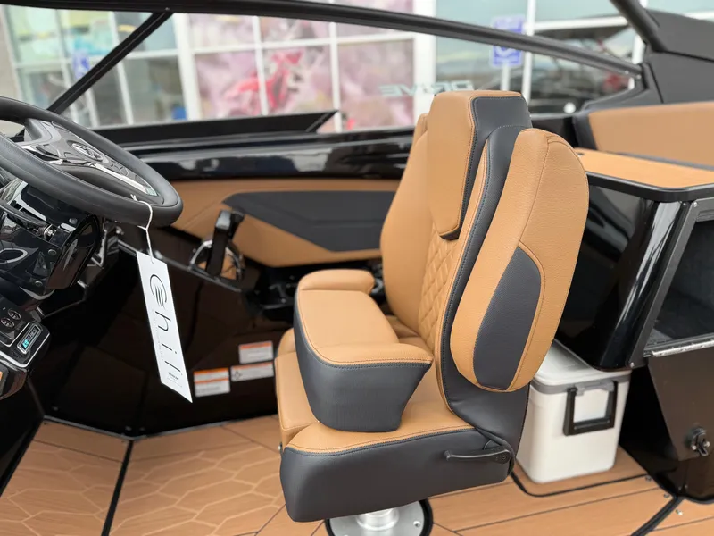 Slide: The Image of 2025 Yamaha Boats 255XD interior with tan and black seating, steering wheel, and modern design. - 45