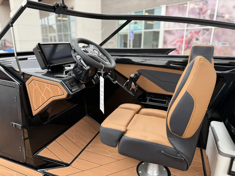 Slide: The Image of 2025 Yamaha Boats 255XD interior with modern dashboard and tan seating. - 46