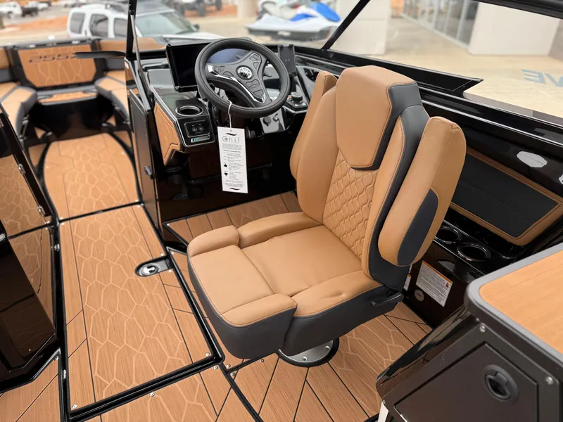 Slide: The Image of 2025 Yamaha Boats 255XD interior with tan seating and modern dashboard. - 47