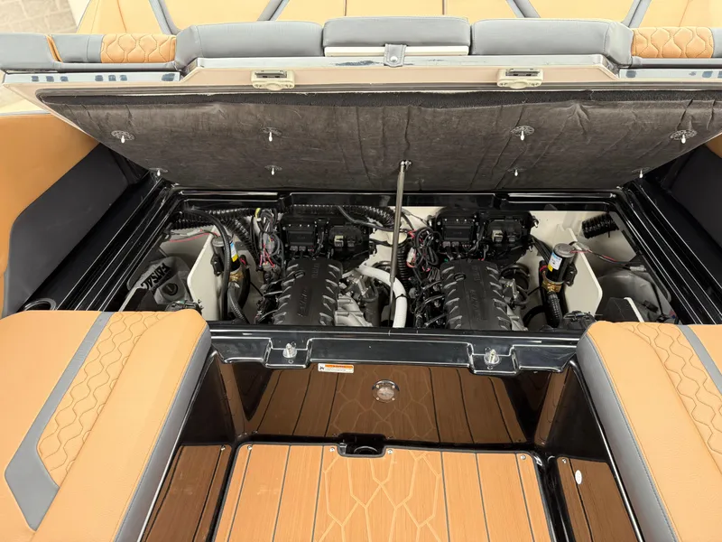 Slide: The Image of 2025 Yamaha Boats 255XD engine compartment with dual engines and tan upholstery. - 73
