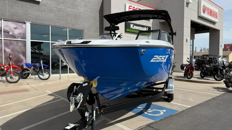 Slide: The Image of 2025 Yamaha Boats 255XD in blue, displayed outside a dealership with motorcycles. - 12