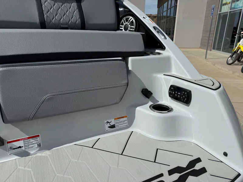 Slide: The Image of 2025 Yamaha Boats 255XD interior detail with gray seating and modern controls. - 19