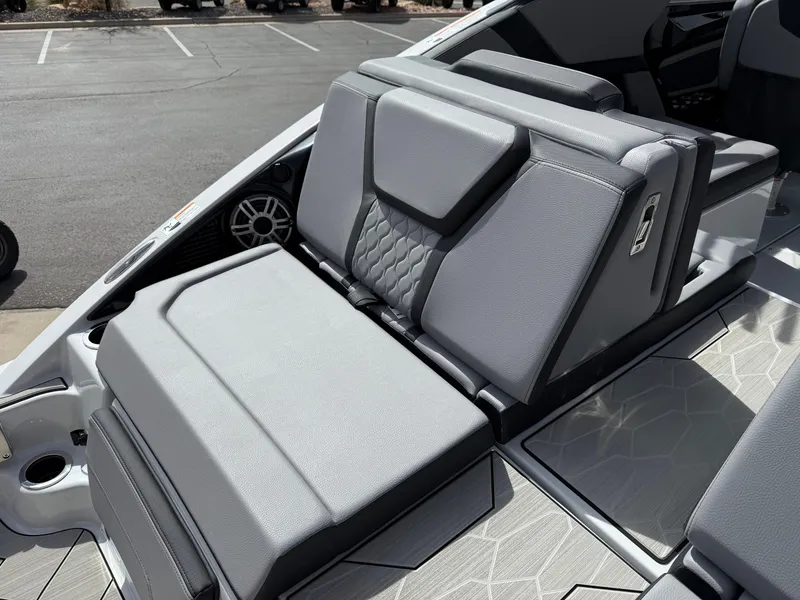 Slide: The Image of 2025 Yamaha Boats 255XD interior seating with gray upholstery and modern design. - 24