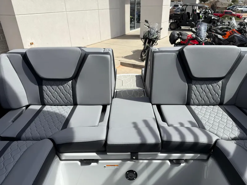 Slide: The Image of 2025 Yamaha Boats 255XD interior seating with gray upholstery and modern design. - 29