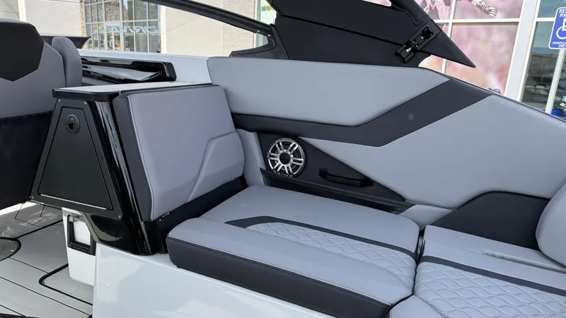 Slide: The Image of 2025 Yamaha Boats 255XD interior with sleek gray seating and integrated speaker system. - 35