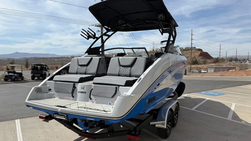 Slide: The Image of 2025 Yamaha Boats 255XD on trailer, featuring sleek design and spacious seating. - 4