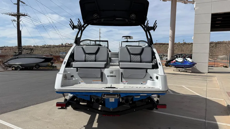 Slide: The Image of 2025 Yamaha Boats 255XD, rear view, parked outdoors, showcasing seating and design features. - 5