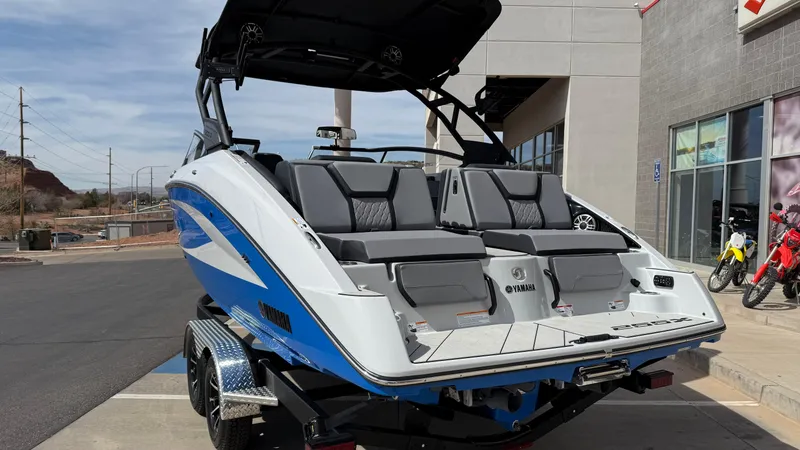 Slide: The Image of 2025 Yamaha Boats 255XD with sleek design and spacious seating, parked outdoors. - 6