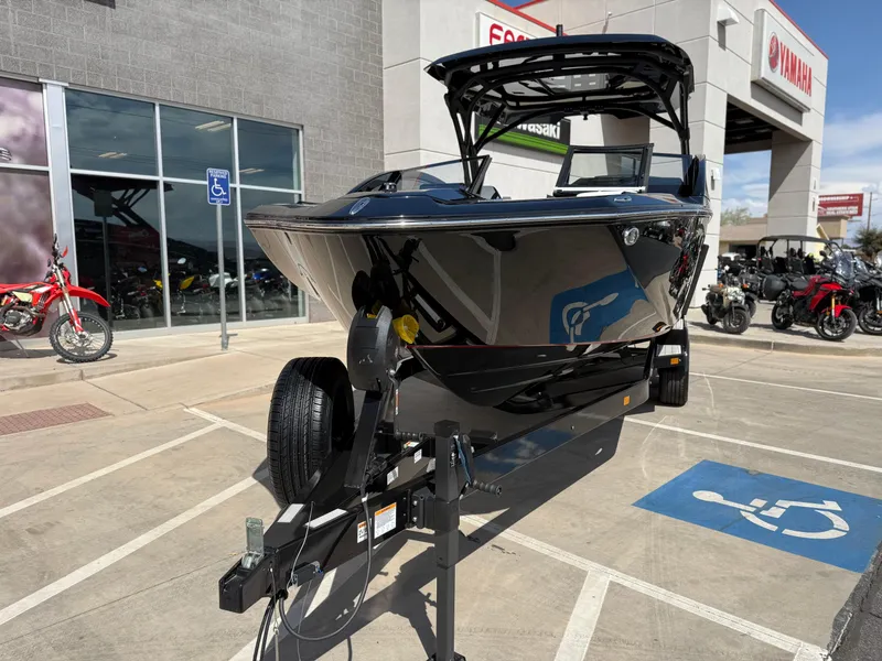 Slide: The Image of 2025 Yamaha Boats 275 SD on trailer outside dealership, showcasing sleek design and modern features. - 11