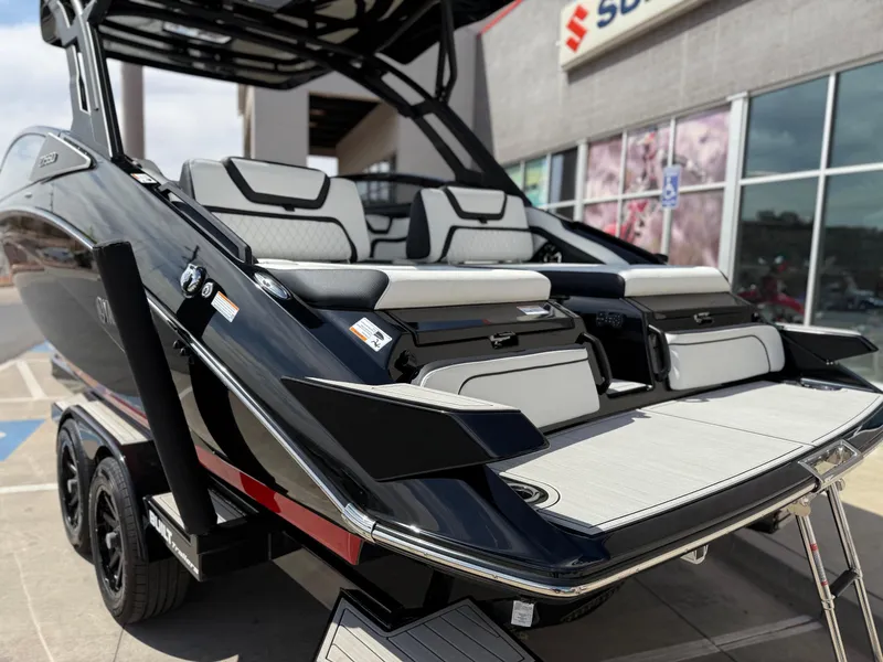 Slide: The Image of 2025 Yamaha Boats 275 SD, sleek black design, luxury seating, on trailer. - 27