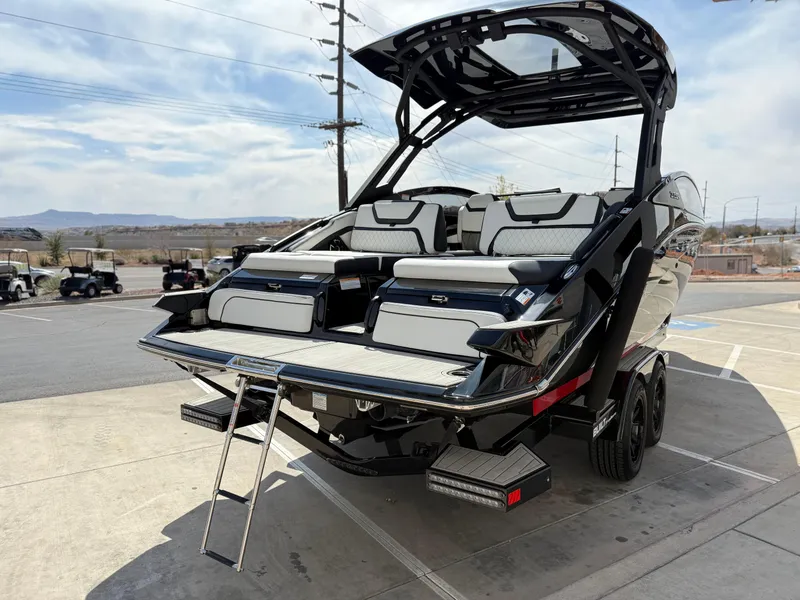 Slide: The Image of 2025 Yamaha Boats 275 SD, sleek black design, dual seating, and swim platform with ladder. - 3