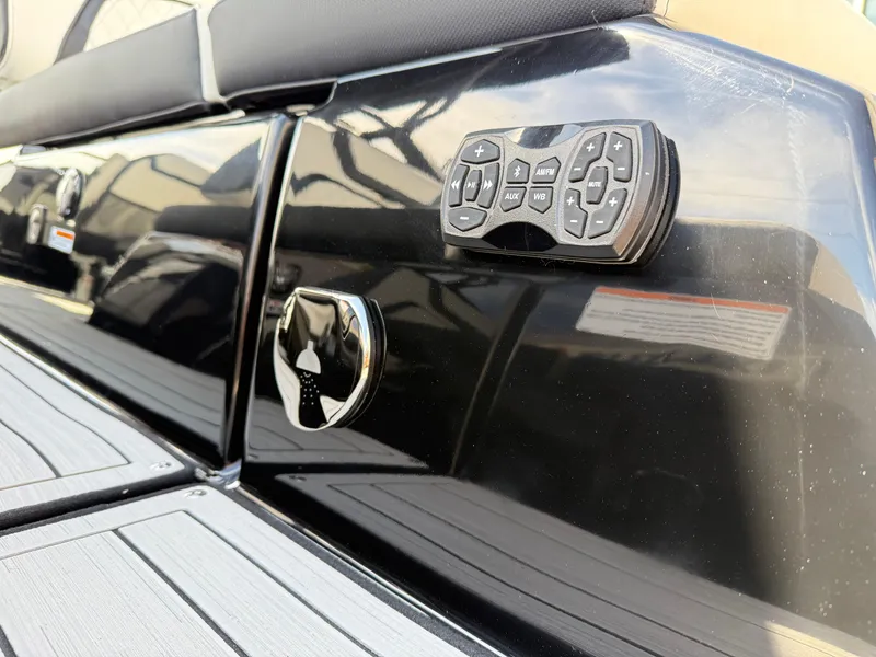 Slide: The Image of 2025 Yamaha Boats 275 SD, black exterior with control panel and seating detail. - 31