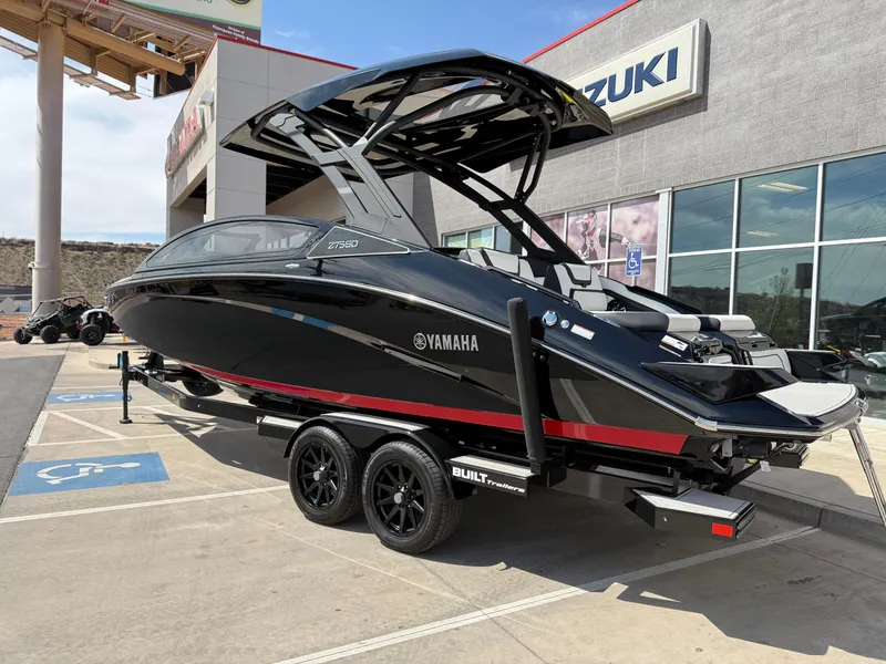 Slide: The Image of 2025 Yamaha Boats 275 SD, sleek black design, parked outside dealership. - 6