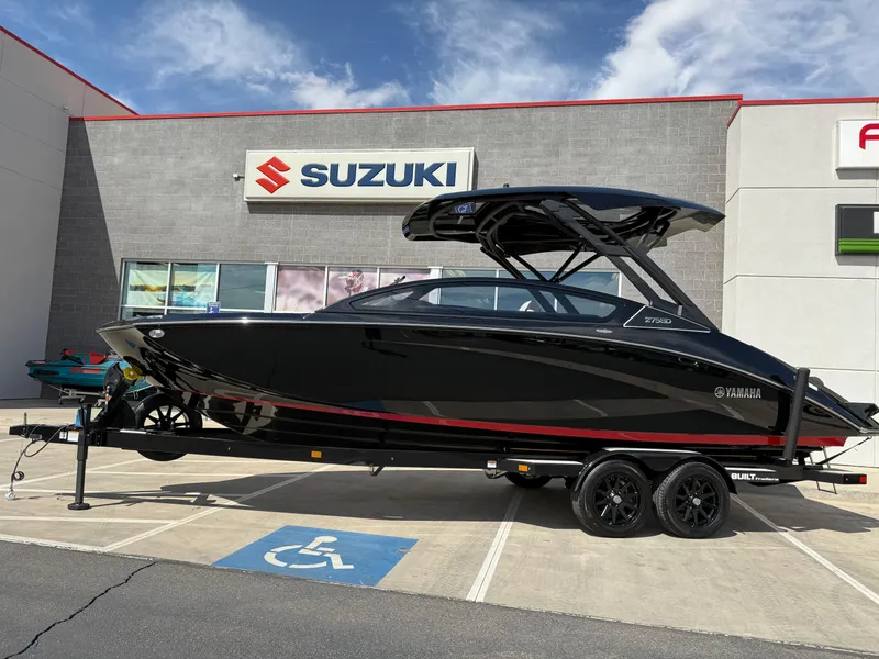 Slide: The Image of 2025 Yamaha Boats 275 SD in black, parked outside a Suzuki dealership. - 8
