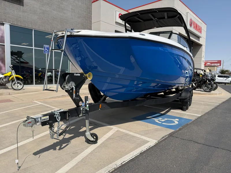 Slide: The Image of 2025 Yamaha Boats AR250 in blue, parked outside a dealership. - 14