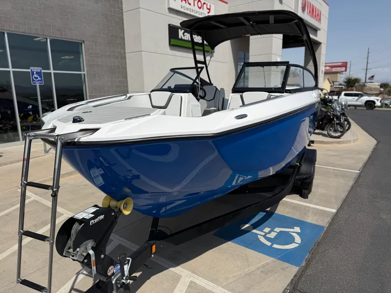 Slide: The Image of 2025 Yamaha Boats AR250 in blue, displayed on a trailer outside a dealership. - 17