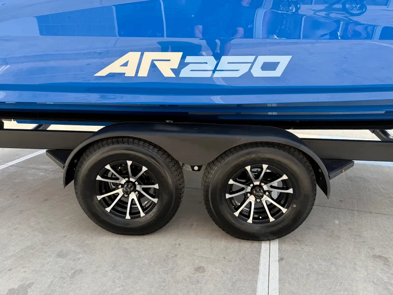 Slide: The Image of 2025 Yamaha Boats AR250 on trailer, showcasing sleek design and dual wheels. - 19