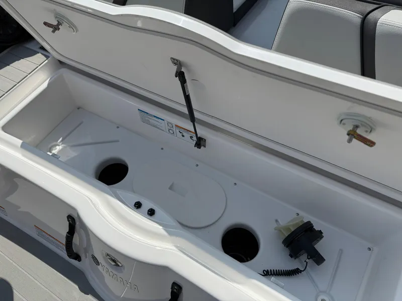 Slide: The Image of Open storage compartment in 2025 Yamaha Boats AR250, showcasing interior features and components. - 29