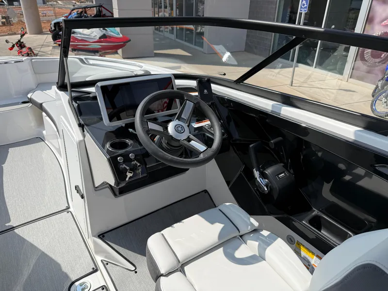 Slide: The Image of 2025 Yamaha Boats AR250 cockpit with steering wheel and modern dashboard controls. - 47