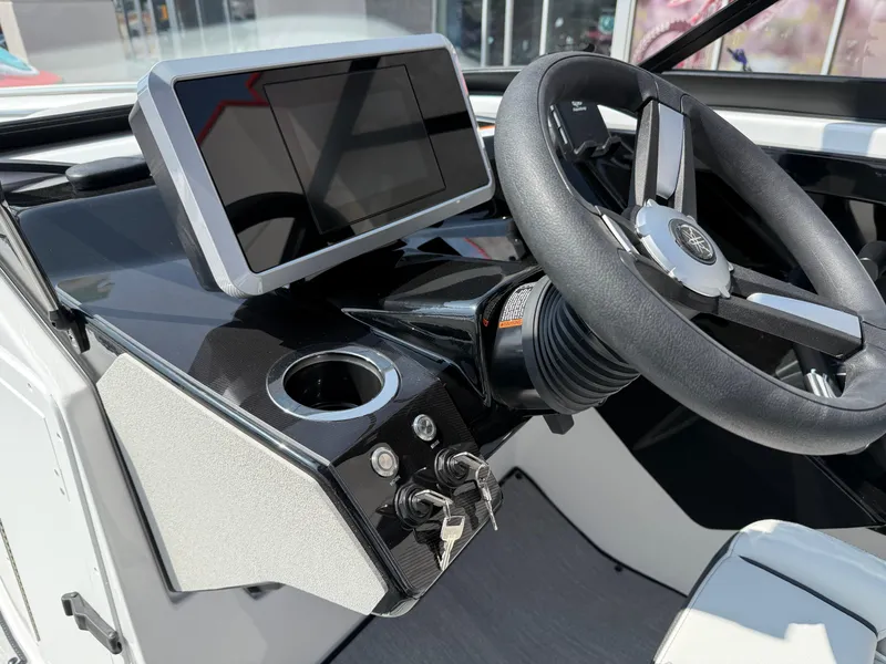 Slide: The Image of 2025 Yamaha AR250 boat dashboard with steering wheel and digital display. - 48