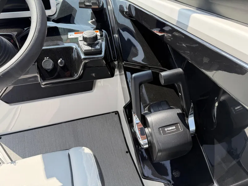 Slide: The Image of 2025 Yamaha Boats AR250 control panel with steering wheel and throttle lever. - 49