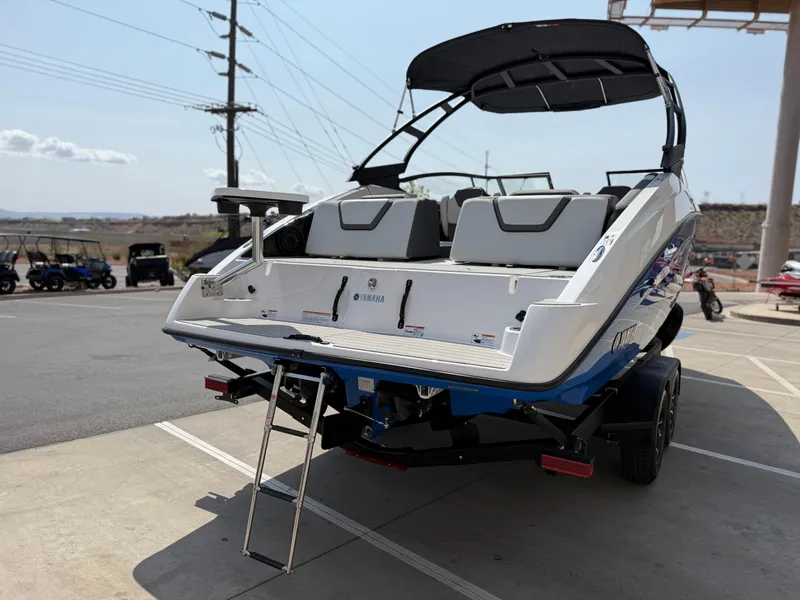 Slide: The Image of 2025 Yamaha Boats AR250, rear view, on trailer, with swim platform and ladder. - 7