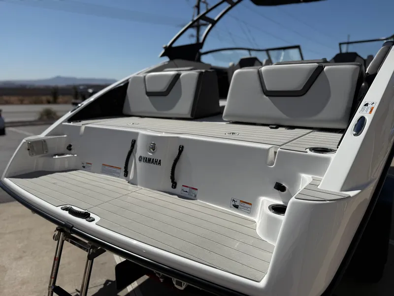 Slide: The Image of 2025 Yamaha Boats AR250 rear view, showcasing spacious deck and seating. - 15