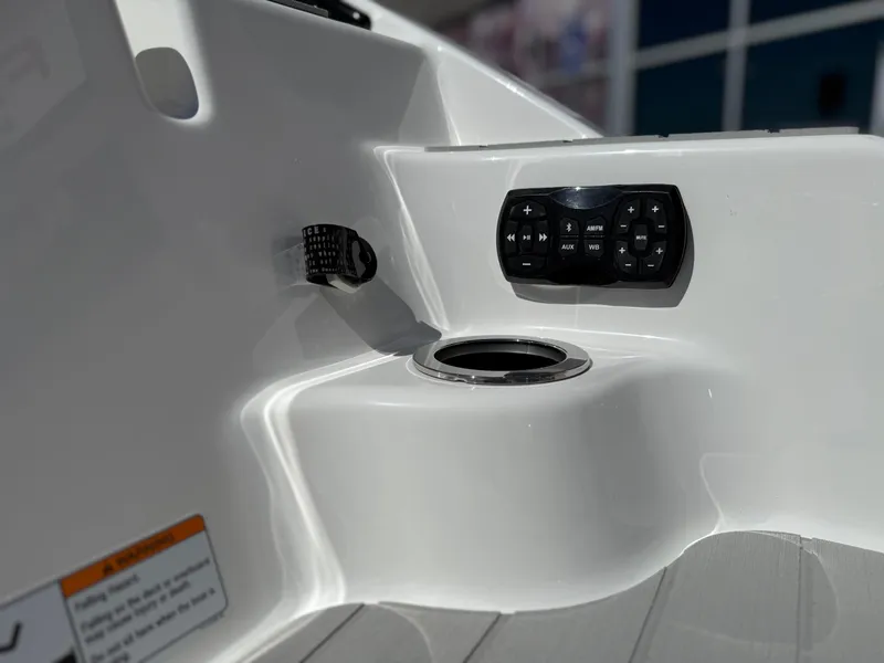 Slide: The Image of 2025 Yamaha Boats AR250 interior detail with control panel and cup holder. - 18