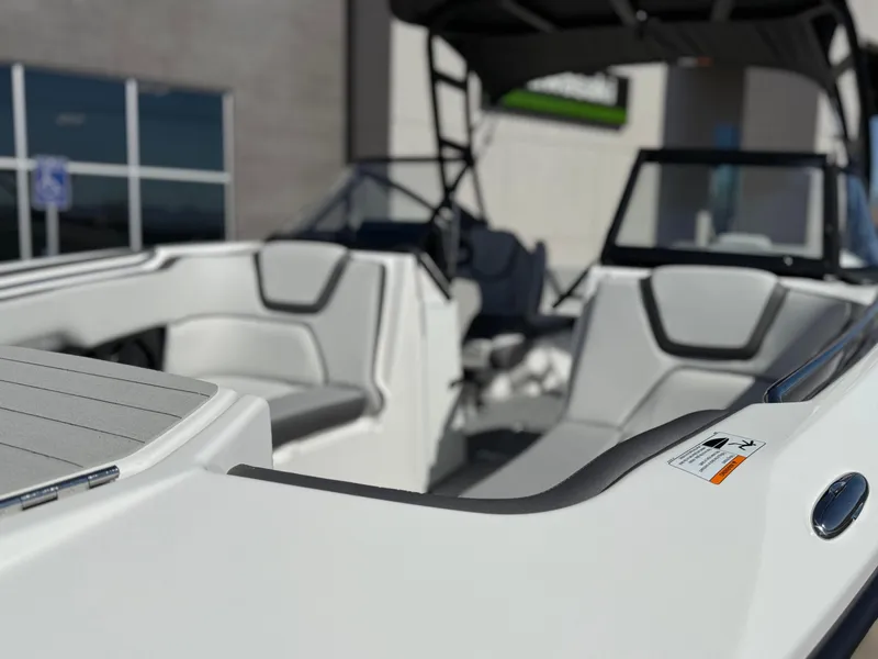 Slide: The Image of 2025 Yamaha Boats AR250 interior with sleek white seating and modern design. - 22