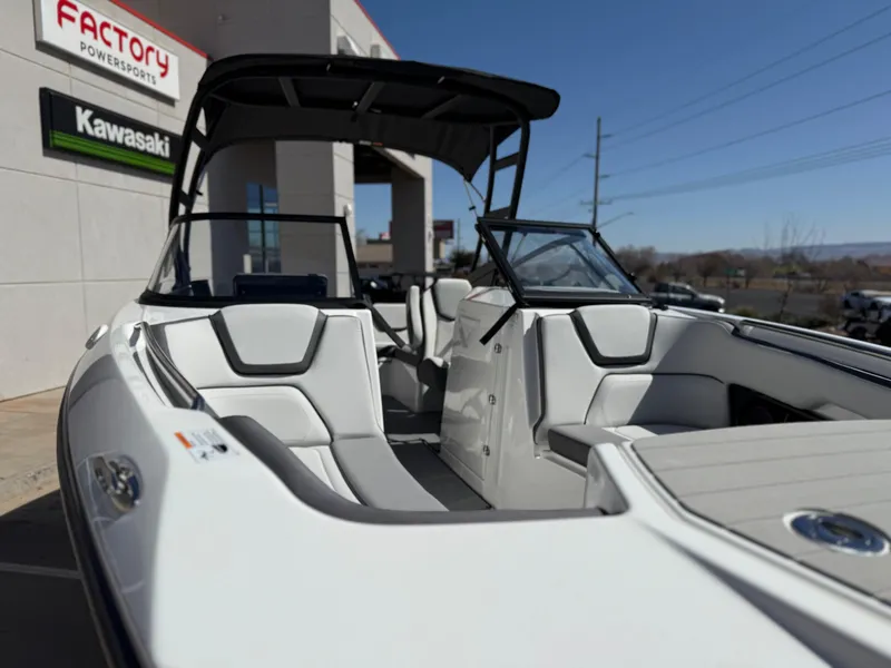 Slide: The Image of 2025 Yamaha Boats AR250 with sleek interior design at a dealership. - 23
