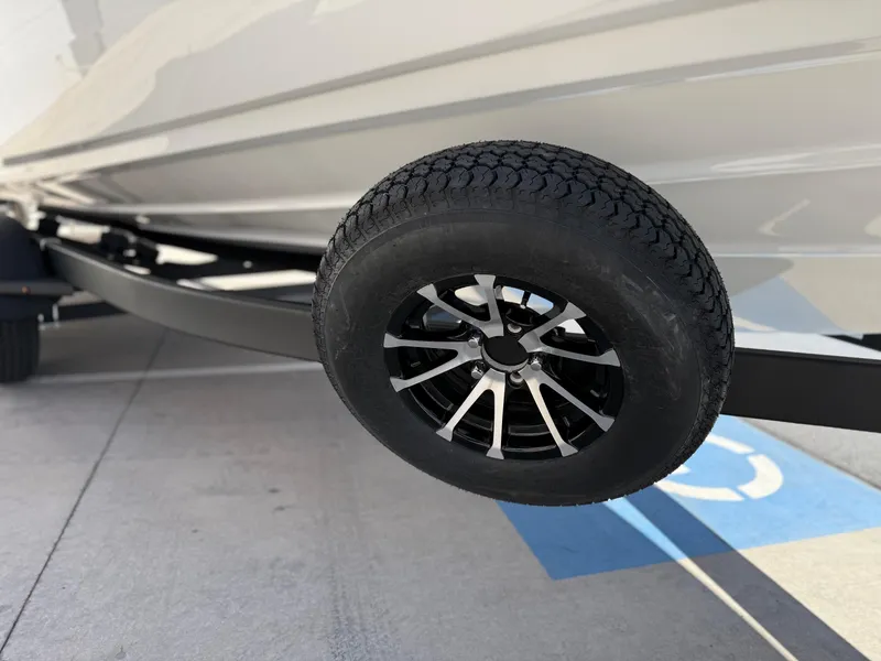 Slide: The Image of 2025 Yamaha Boats AR250 trailer wheel close-up in parking lot. - 27