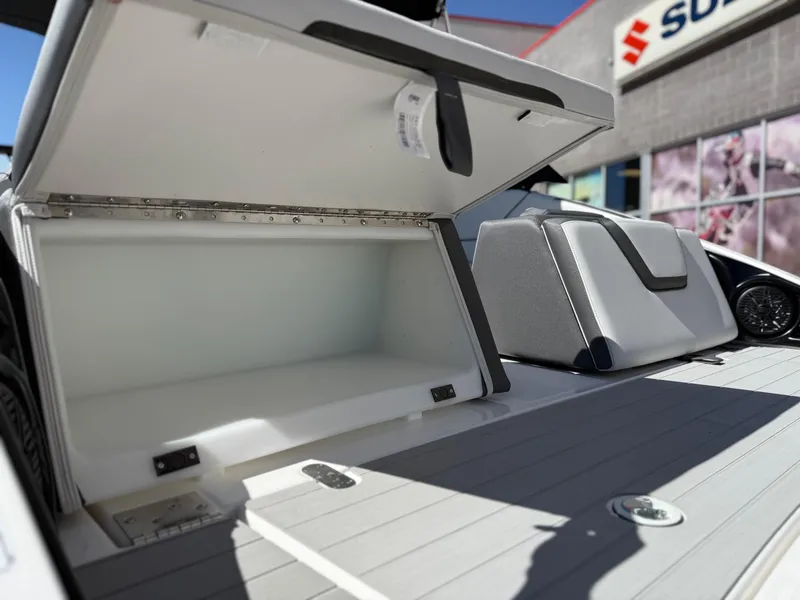 Slide: The Image of 2025 Yamaha Boats AR250 storage compartment open on deck. - 28