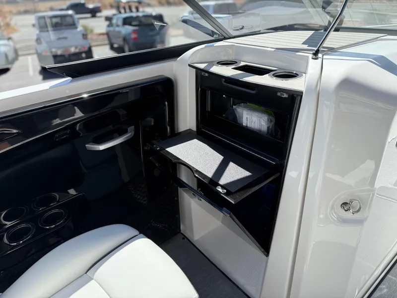 Slide: The Image of 2025 Yamaha Boats AR250 interior with storage compartment and seating. - 49