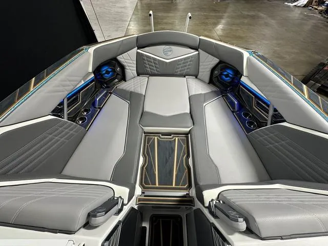 Slide: The Image of 2025 Tigé 25ZX boat interior with luxurious gray seating and blue LED accents. - 13