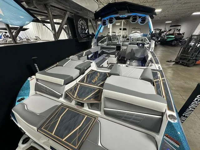 Slide: The Image of 2025 Tigé 25ZX boat interior with luxurious seating and modern design in a showroom. - 5