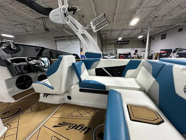 Slide: The Image of 2022 Tigé Z1 boat interior with blue and white seating, modern dashboard, and spacious layout. - 10